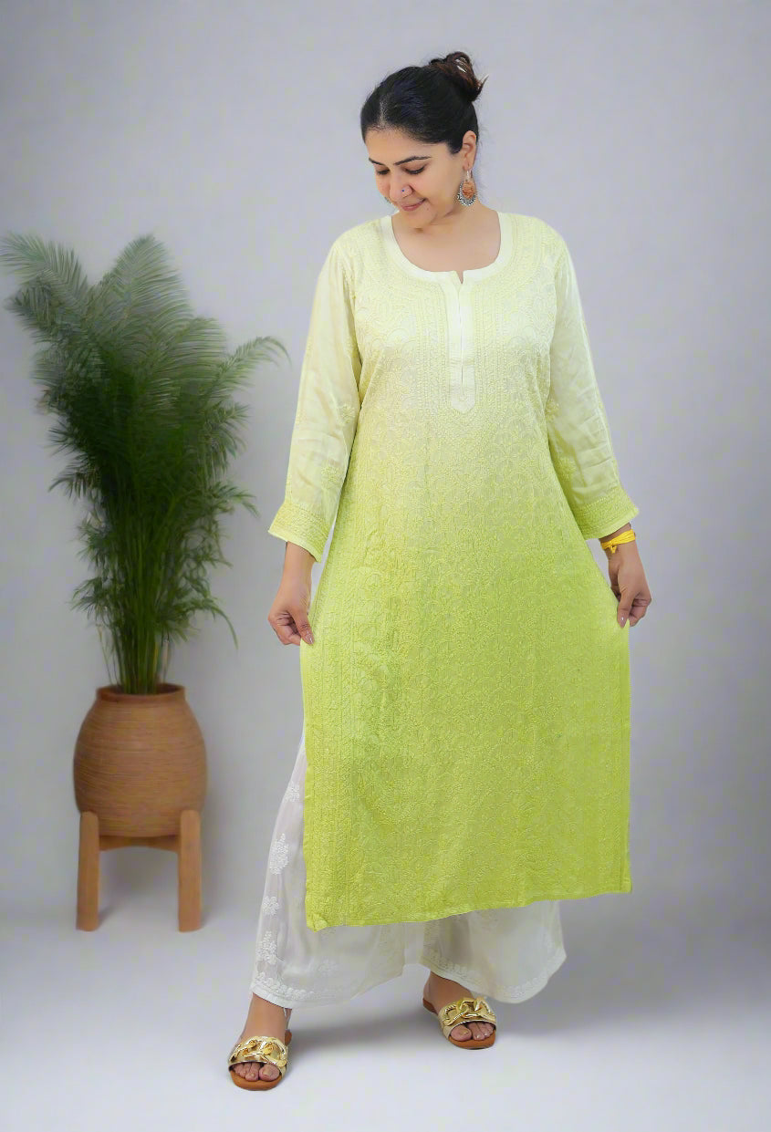Woman wearing a light green and white ombre kurta with white pants on a white background