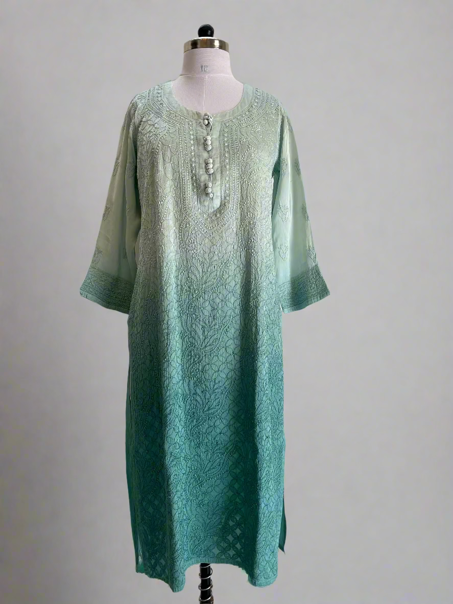 Green embroidered dress on a mannequin against a plain background
