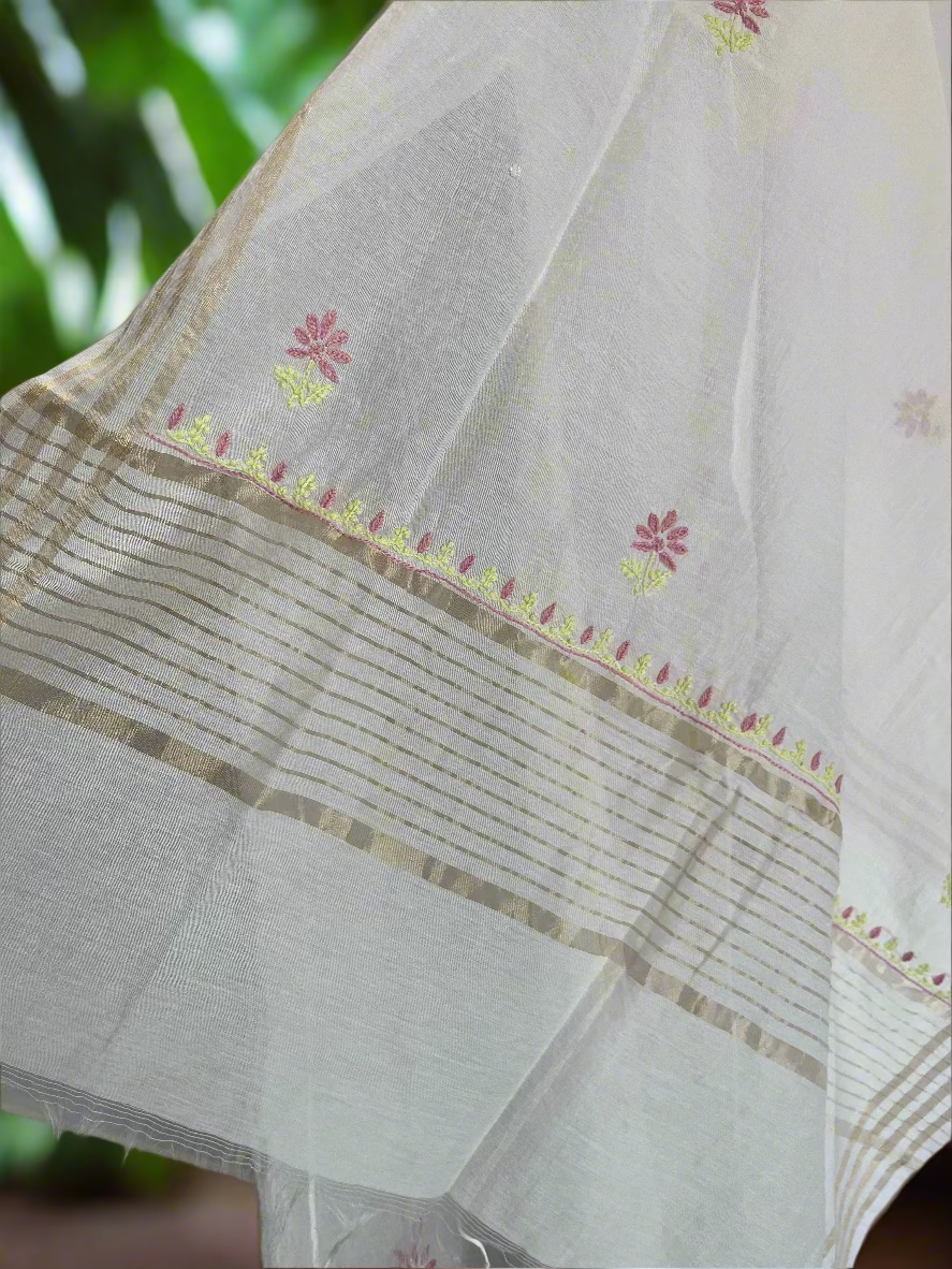White fabric with floral embroidery and gold border