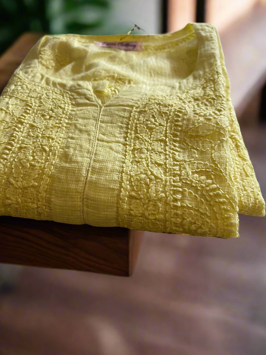 Yellow textured fabric on a floral-patterned surface