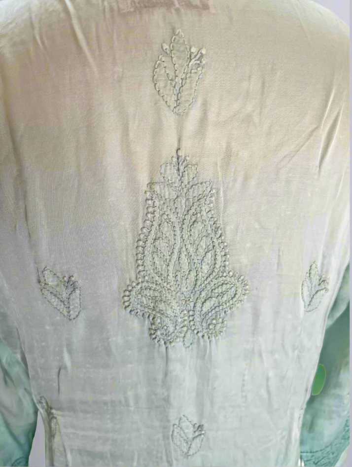 Light green embroidered garment on a white background