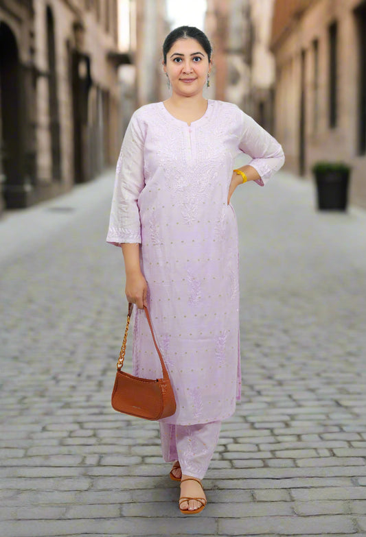 Woman wearing a light purple traditional outfit with a brown handbag on a white background