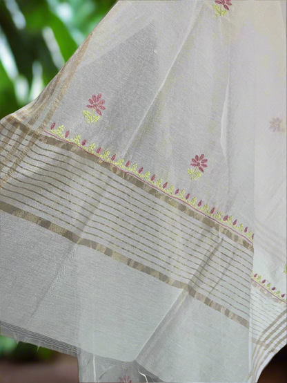 White fabric with floral embroidery and gold border