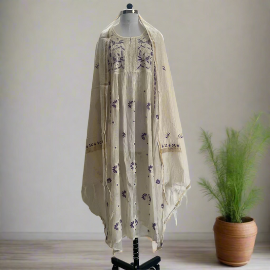 Mannequin wearing a cream-colored embroidered dress against a plain background
