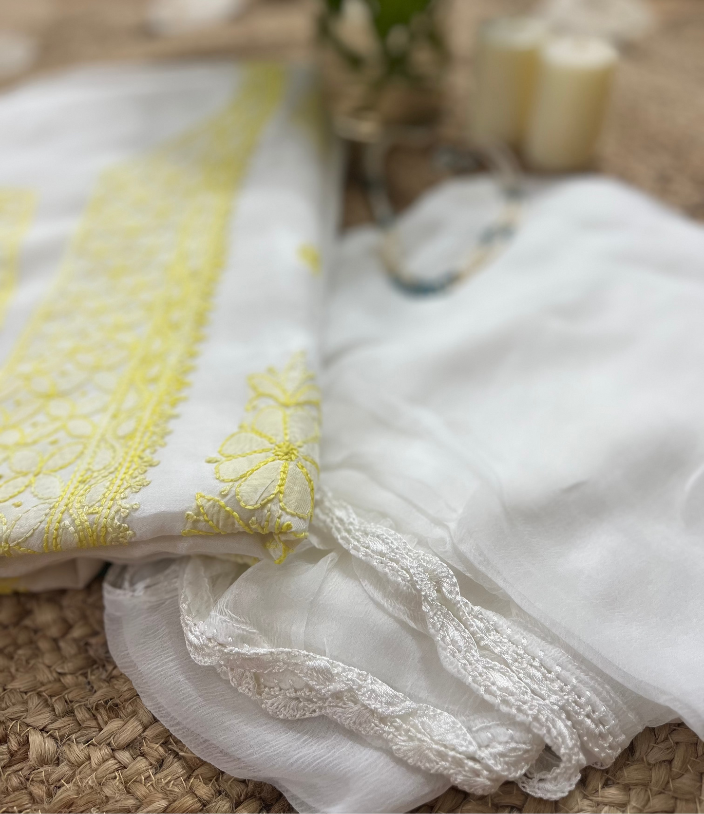 White fabric with yellow embroidery on a textured surface