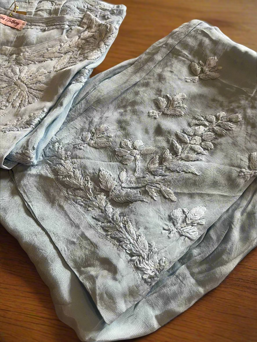 Embroidered fabric with floral patterns on a beige surface