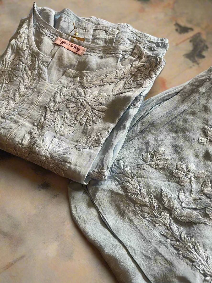 Two floral-patterned shirts on a textured surface