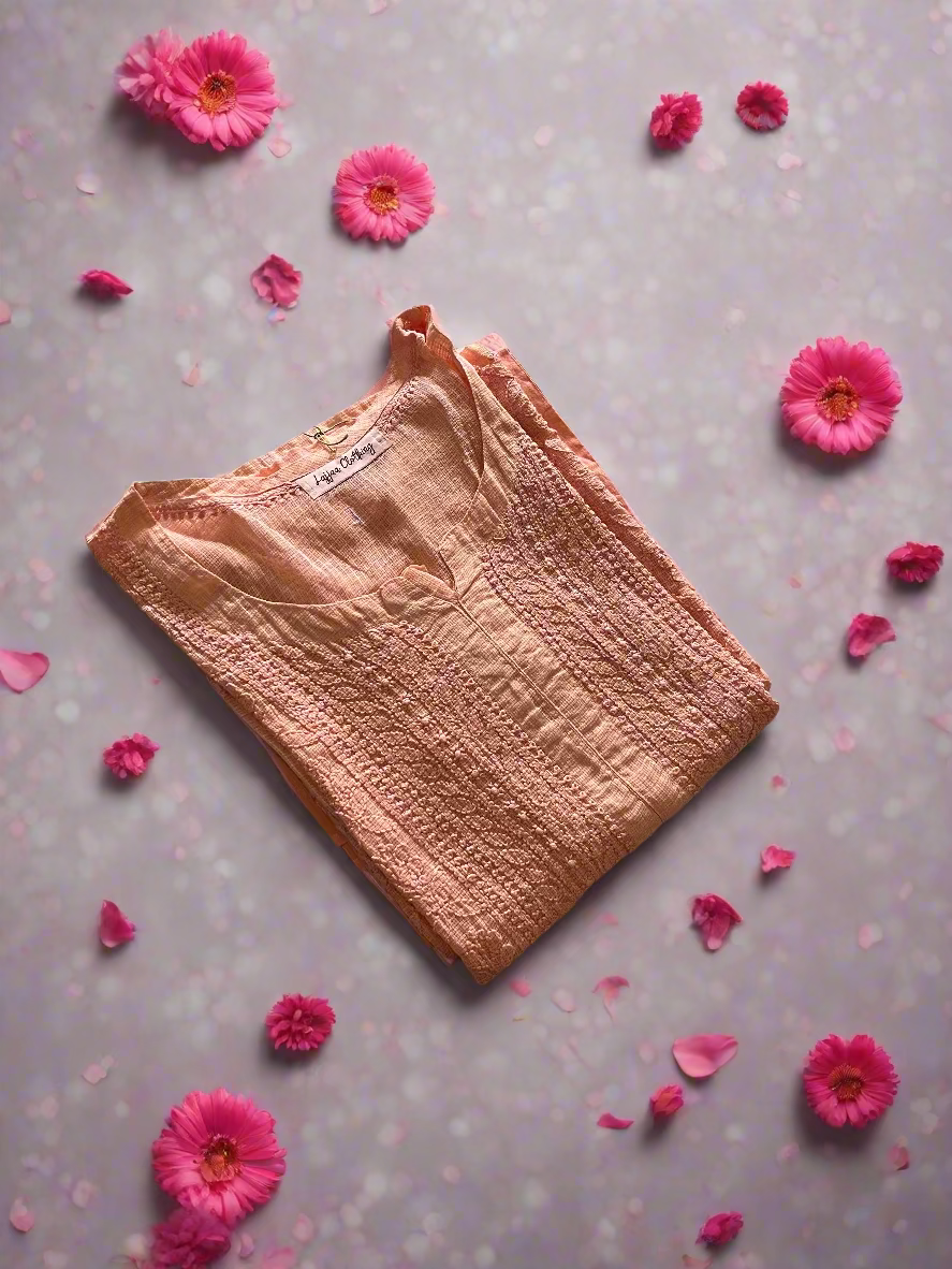 Pink quilted item on a floral-patterned bedspread